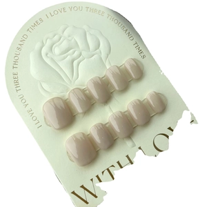 Glossy nude pink short square press-on nails set displayed on a decorative card