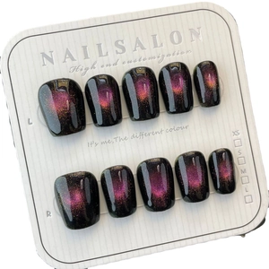 Cat eye press-on nails in purple and black gradient with 10 pieces on display card