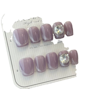 Handmade taro purple cat eye press-on nails with silver glitter and large crystal rhinestones