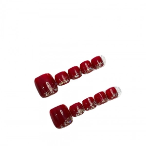 Glossy burgundy press-on toenails with glitter gradient and rhinestone accents