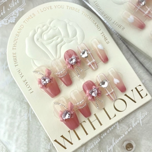 Pink plaid press-on nails with bow and heart diamond charms in a long coffin shape