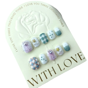 Handmade press-on nails set featuring pearl shells, starfish, and blue grid patterns