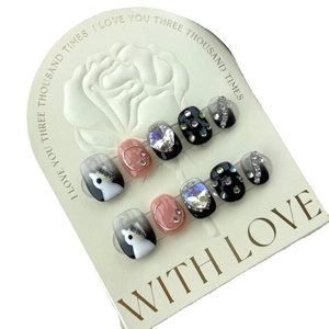 Handmade short press-on nails in black and pink with 3D rhinestones and cat art