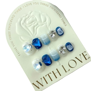 Handmade mermaid blue press-on nails with 3D crystal hearts and marble cat eye effects
