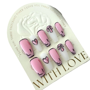 2D cartoon style pink and white press-on nails with heart patterns on white arch card