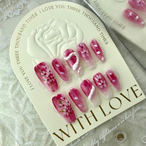 Pink and white marble press-on nails with 3D floral accents and snake-shaped art