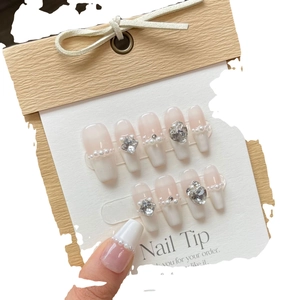Handmade press-on nails with french white tips, soft pink gradient, pearls and rhinestones