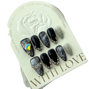 Handmade dark marble almond press-on nails with rainbow gems and rhinestones