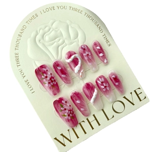 Handmade press-on nails set with pink floral designs and 3D white snake relief accents