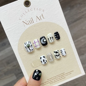 Handmade press-on nails with 3D black white anime style designs and pearl charms