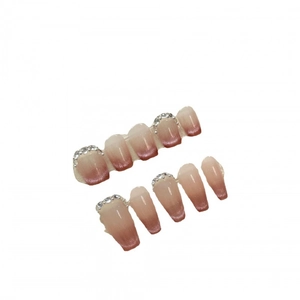 Pink cat eye press-on nails with glitter gradient and rhinestones in coffin shape