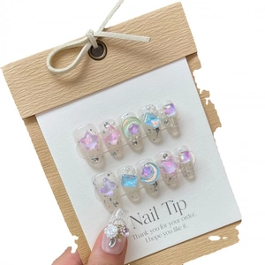 Handmade press-on nails featuring silver glitter and 3D star moon gemstone charms