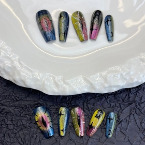 Handmade cat eye press-on nails with celestial star patterns and aurora coffin shape
