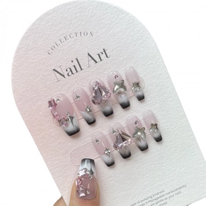 Pink and black Y2K press-on nails with heart, butterfly and star charms for women