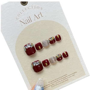 Burgundy press-on toenails with silver glitter, pearls, and rhinestones on display