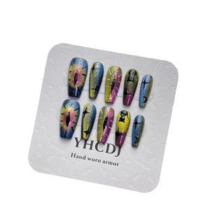 Cat-eye press-on nails set with aurora star and moon patterns on a display card