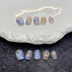 Handmade cat eye press-on nails with 3D blue butterfly and pearl baroque accents