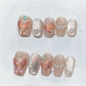 Handmade mermaid style press-on nails with pink glitter, 3D fishtail, and pearl accents