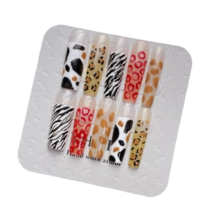 Extra long animal print press-on nails featuring leopard and zebra textures on white card
