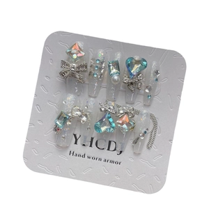 Luxurious white bridal press-on nails with heart gems, bows and shimmering pearls