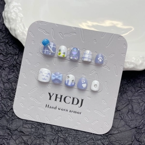 Kids press-on nails set with blue and white floral patterns and 3D bow accents