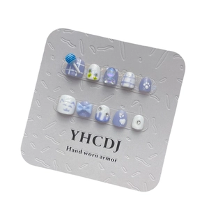 Blue and white handmade press-on nails set with 3D candy, bear, and floral designs