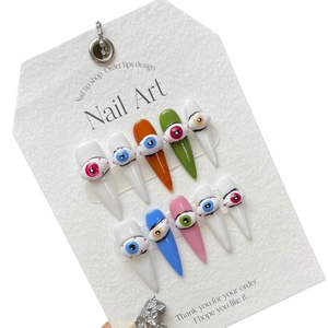 Handmade stiletto press-on nails with colorful 3D evil eye charms and vibrant graffiti art