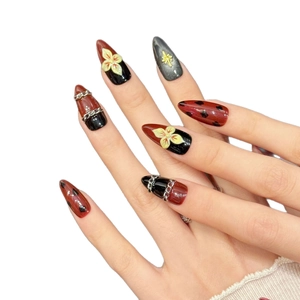 Gothic press-on nails featuring red and black gradient with gold angel relief and chains