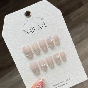 Handmade pink cat-eye press-on nails with 3D butterfly charms and elegant pearls