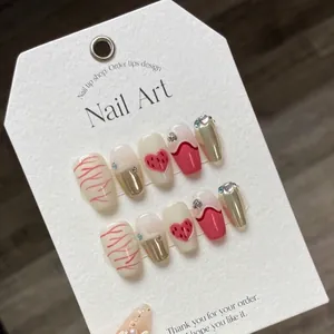 Pink flame and metallic silver handmade press-on nails with heart charms on display card