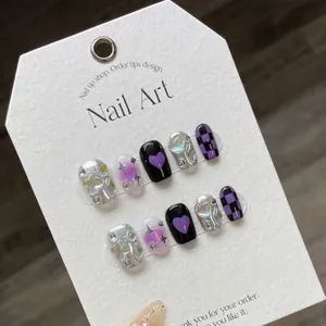 Handmade Y2K press-on nails in purple and black with silver chrome checkerboard and hearts