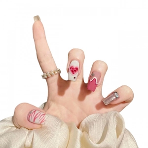 Pink press-on nails with heart patterns, flame designs, and silver metallic rhinestones