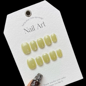 Short square press-on nails in mustard green with rainbow cat eye glitter effect