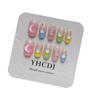 Handmade macaron press-on nails with colorful 3D stars and moons in vibrant summer style