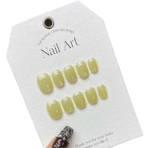 Handmade mustard green cat eye press-on nails with holographic shimmer and chrome heart charms