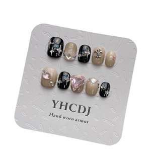 Handmade gradient press-on nails in black and nude with pink heart diamond and silver charms
