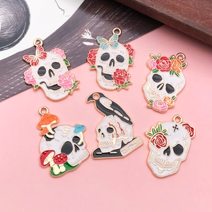 Detail of six Halloween skull and floral alloy charms for DIY necklace making