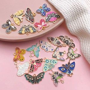Close-up of colorful enamel butterfly and moth alloy pendants for DIY jewelry making
