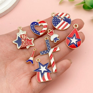Set of 8 American flag themed enamel charms including star heart and bear on hand