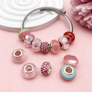 Pink charm bracelet set with sparkling rhinestones, glass beads and striped spacers