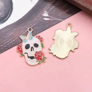Macro detail of skull and rose alloy pendant showing enamel front and textured gold back