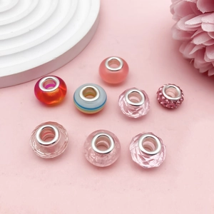 Macro shot of pink striped large hole glass beads with rhinestones for DIY jewelry making