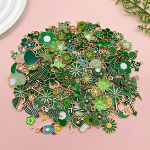 Vista dall'alto di ciondoli smaltati verdi cactus e fiori per creazioni gioielli