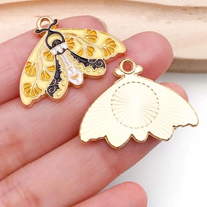 Front and back detail of yellow butterfly enamel pendant charms for DIY jewelry making
