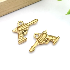 Detailed view of two gold stainless steel revolver charms for DIY jewelry making