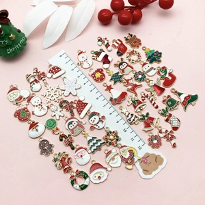Bunte Weihnachts-Emaille-Anhänger-Set mit Weihnachtsmann und Rentier auf rosa Hintergrund