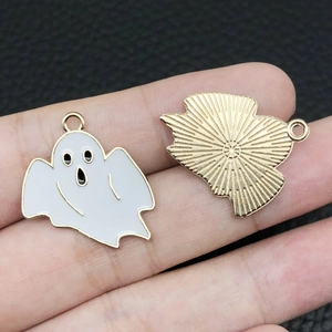 Macro view of Halloween ghost charms showing enamel face and textured gold metal back