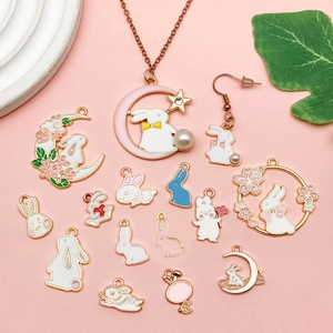 Cartoon enamel bunny charms and rabbit pendant necklace set on a soft pink background