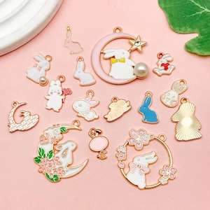 Close-up of enamel bunny charms with pearls and rhinestones for DIY jewelry making