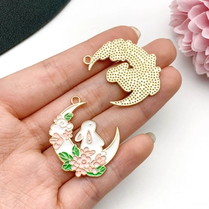 Detail of moon rabbit alloy charm featuring pink cherry blossom and golden honeycomb back